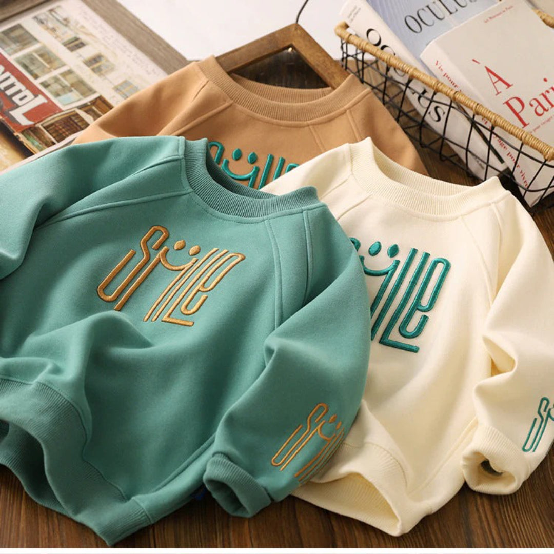 Unisex Kinderpullover mit einem fröhlichen Smile-Design